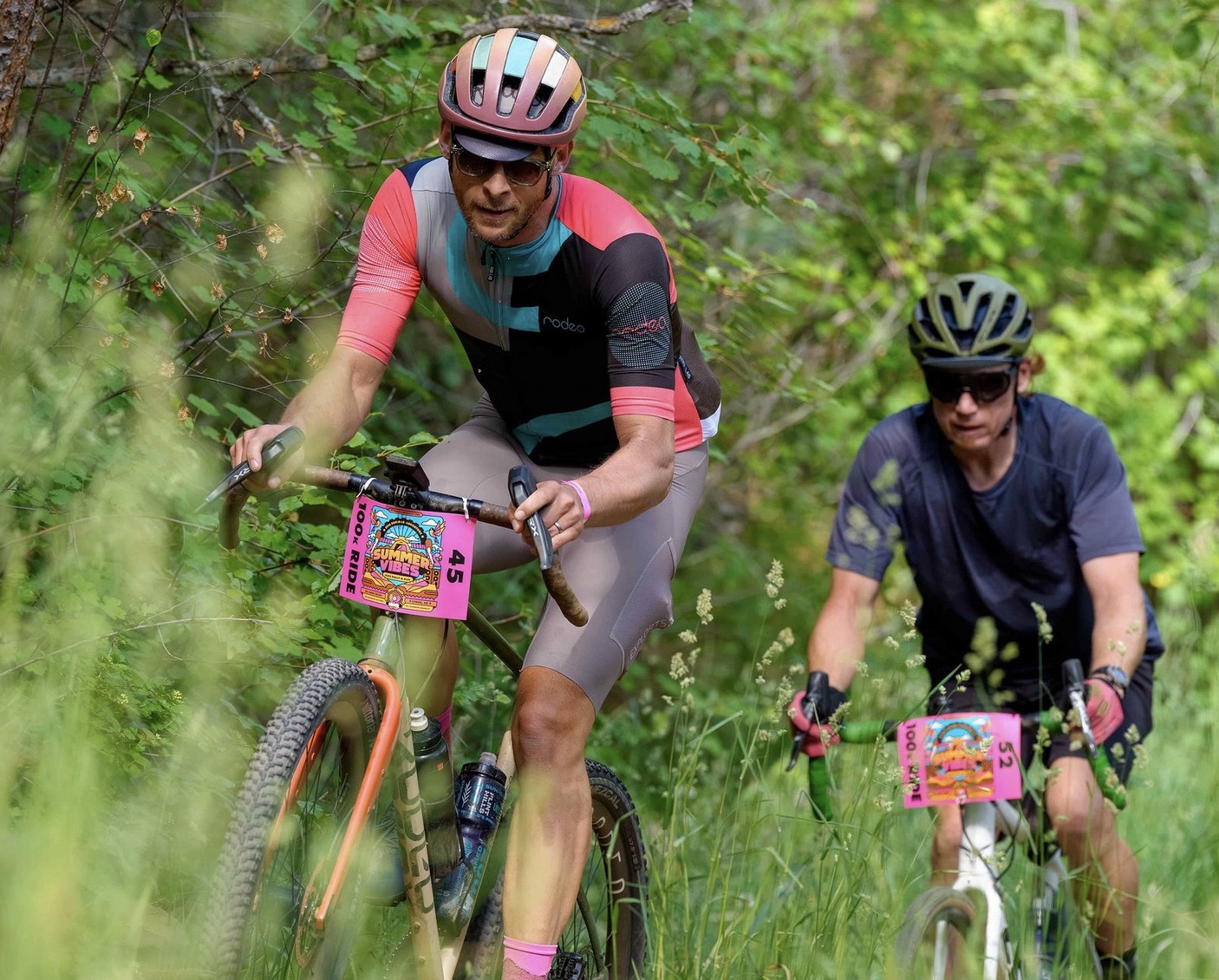 Gravel rider in a pink jersey on a dirt road near Lyons