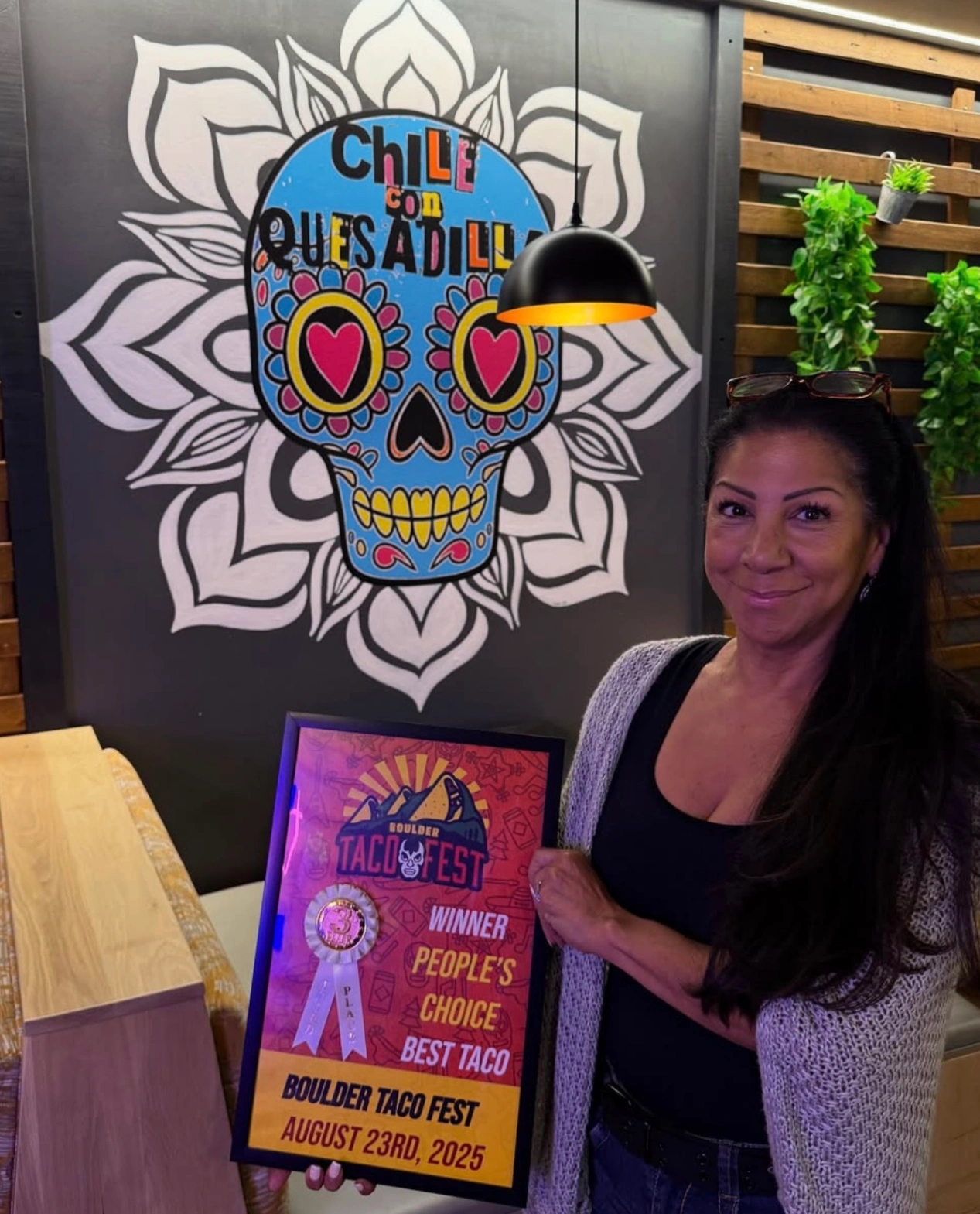 A woman holding an award plaque at Boulder Taco Fest on August 23rd, 2025